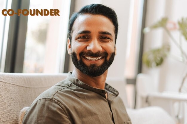 portrait-handsome-smiling-indian-businessman-employee-sitting-modern-office_695242-21229
